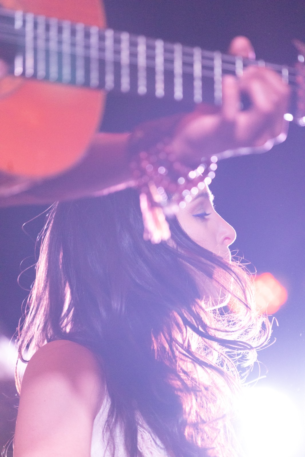 An AUREA gathering. A woman lost in the music, lit from behind.